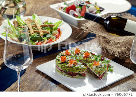 Beautifully decorated catering banquet table with different food snacks and appetizers Beautifully decorated catering banquet table with different food snacks and appetizers 76006771
