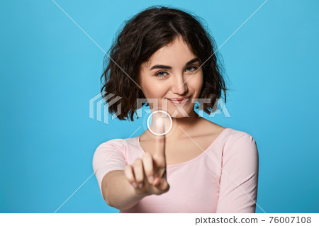 woman using touch screen on the blue background. woman using touch screen on the blue background. 76007108