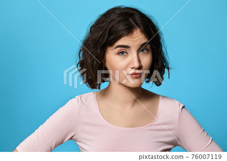 woman with curly hair skeptic and frowning upset woman with curly hair skeptic and frowning upset 76007119