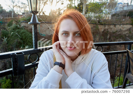 Portrait of young european woman in summer cafe. Portrait of young european woman in summer cafe. 76007298