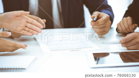 Group of business people and lawyers discussing contract while sitting at the table in office, close-up. Successful teamwork, cooperation and agreement concepts Group of business people and lawyers discussing contract while sitting at the table in office, close-up. Successful teamwork, cooperation and agreement concepts 76008130