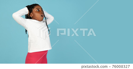 Handsome african little girl portrait isolated on blue studio background with copyspace 76008327