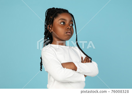 Handsome african little girl portrait isolated on blue studio background with copyspace Handsome african little girl portrait isolated on blue studio background with copyspace 76008328