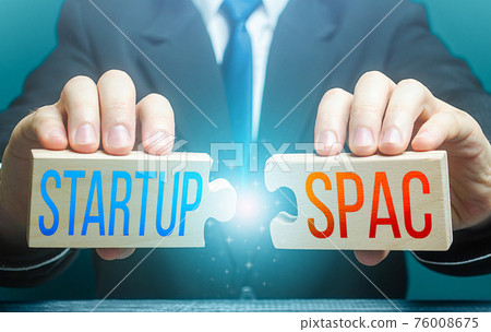 Man connects puzzles with words Startup and SPAC. Simplified fundraising and funding procedure for merger two companies into a new one. Benefits over IPO, higher risks. Forecasting deal profitability 76008675