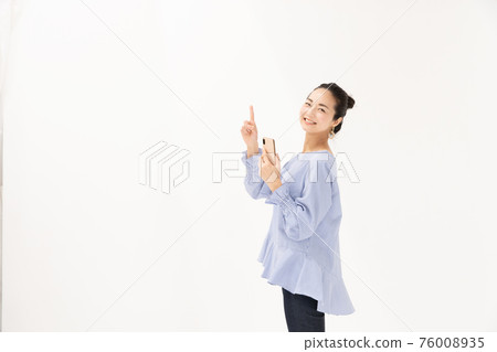 A woman with a smartphone pointing A woman with a smartphone pointing 76008935