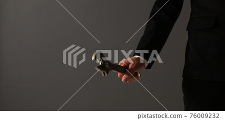 Men's suit with a wrench at hand 76009232