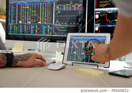 Trader checking stock market Trader checking stock market 76009622