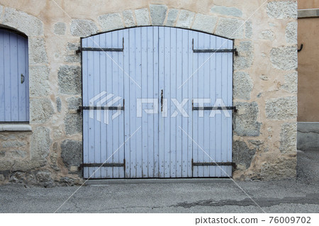 Closed large blue door in an old house in the Provence, France Closed large blue door in an old house in the Provence, France 76009702