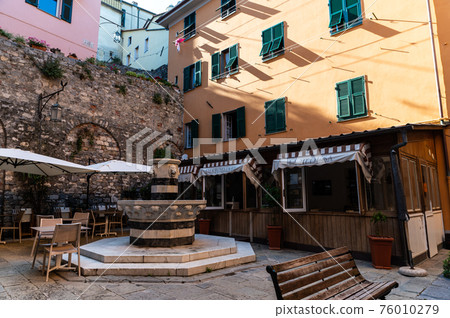 Porto Venere, Liguria, Italy. June 2020. Glimpse of Piazza Centinaro square in the old fishing village with the black and white marble striped fountain and the Lion's heads. Porto Venere, Liguria, Italy. June 2020. Glimpse of Piazza Centinaro square in the old fishing village with the black and white marble striped fountain and the Lion's heads. 76010279