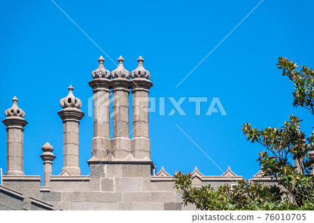 The walls and towers of the old palace on the background of a blue sky The walls and towers of the old palace on the background of a blue sky 76010705