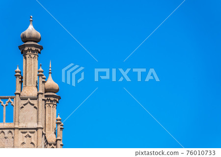 The walls and towers of the old palace on the background of a blue sky The walls and towers of the old palace on the background of a blue sky 76010733