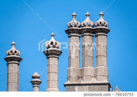 The walls and towers of the old palace on the background of a blue sky The walls and towers of the old palace on the background of a blue sky 76010735