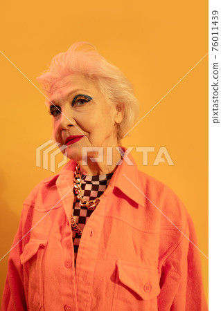 Woman looking confidently at the camera while posing in studio 76011439
