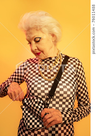 Woman zips up her bag while spending time at the studio 76011488