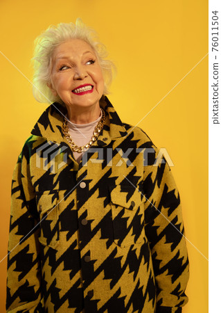 Woman smiling widely while enjoying life in old age 76011504