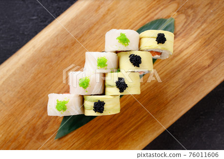 Seafood delicatessen sushi rolls set on board 76011606