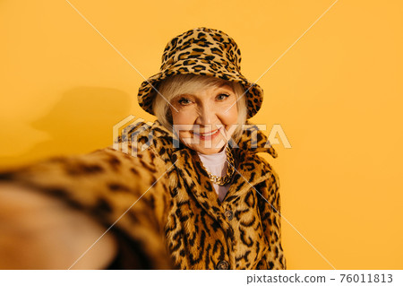 Woman wearing total leopard look taking selfie while spending time at the studio 76011813