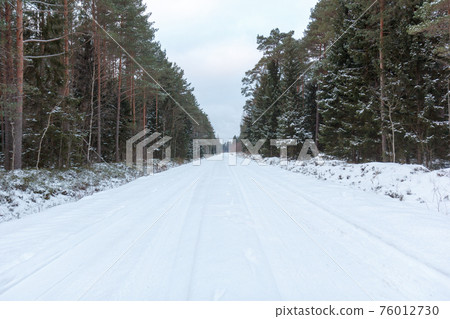 Empty snow covered road Empty snow covered road 76012730