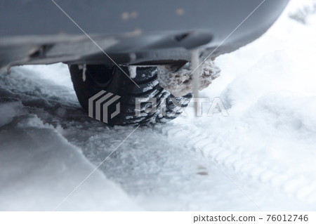 Closeup of car tire in winter Closeup of car tire in winter 76012746