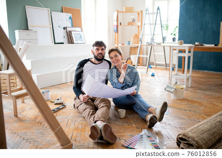 Mid adults couple planning indoors at home, relocation and diy concept. 76012856
