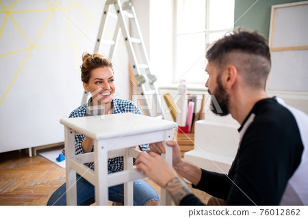 Mid adults couple renovating furniture indoors at home, relocation and diy concept. 76012862