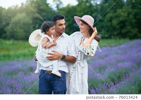 Happy family posing in lavender field 76013424