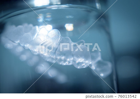 Transparent tooth aligner inside a crystal glass Transparent tooth aligner inside a crystal glass 76013542