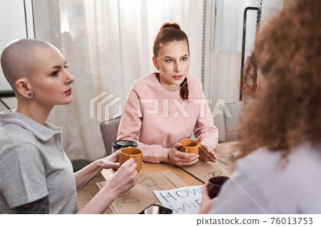 Girls drinking tea and talking about women's rights together Girls drinking tea and talking about women's rights together 76013753