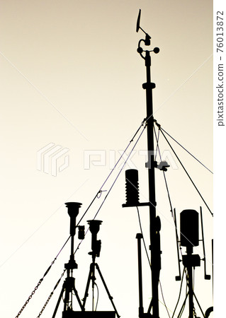 Weather station in silhouette over the sky at sunset 76013872