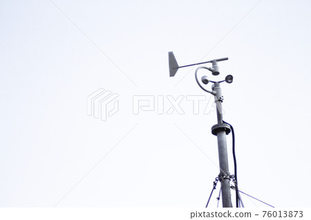 Weather station in silhouette over the sky at sunset 76013873