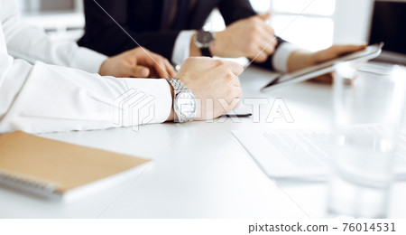 Unknown business people using tablet computer in modern office. Businessman or male entrepreneur is working with his colleague at the desk 76014531