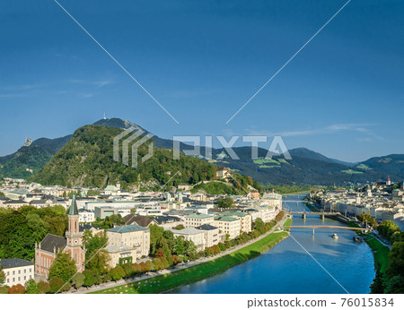 Old town of Salzburg flanked by Kapuzinerberg hill. Capital city of State of Salzburg in Austria, Europe. Historic centre, Salzach river and Alpine surroundings. Birthplace of Wolfgang Amadeus Mozart. 76015834