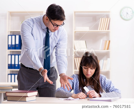 Male lecturer giving lecture to female student Male lecturer giving lecture to female student 76017581