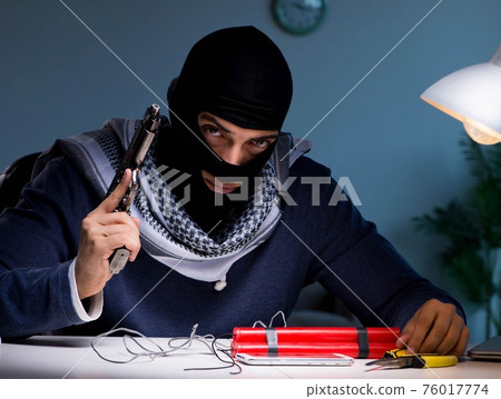 Terrorist bomber preparing dynamite bomb 76017774