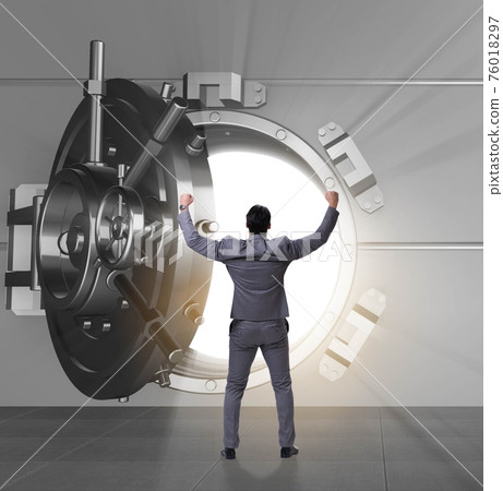 Businessman in front of banking vault door Businessman in front of banking vault door 76018297