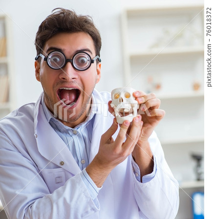 Crazy doctor studying human skeleton 76018372