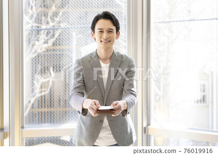 Man presenting a business card (front) Man presenting a business card (front) 76019916