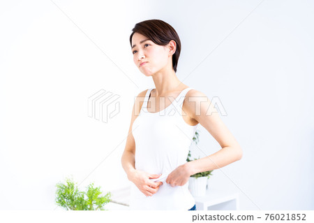 Middle-aged woman who cares about sagging stomach Middle-aged woman who cares about sagging stomach 76021852