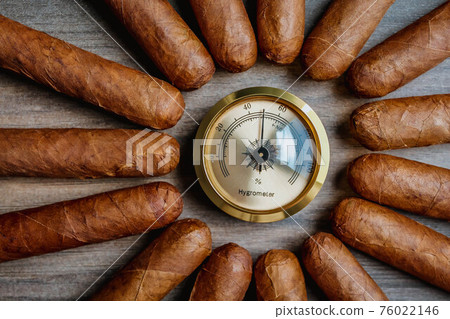 Cigars with humidor hygrometer on the wooden background 76022146