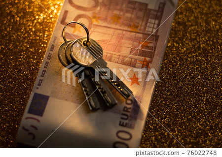 keys and money banknotes on golden background keys and money banknotes on golden background 76022748