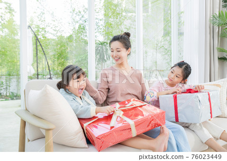 Portrait of happy cheerful family, young mother and two daughters 136 76023449