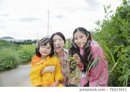 Portrait of happy cheerful family, young mother and two daughters 274 Portrait of happy cheerful family, young mother and two daughters 274 76023651