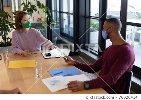 Two diverse business people working in creative office 76026414