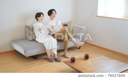 一對夫婦在客廳裡看電視 76027809