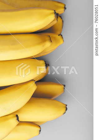 Fresh bunch of yellow bananas isolated on a Gray background Trendy colors of 2021 Fresh bunch of yellow bananas isolated on a Gray background Trendy colors of 2021 76028051