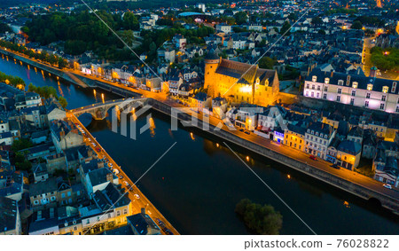 Evening aerial view of Laval with buildings, river Mayenne and old bridge Evening aerial view of Laval with buildings, river Mayenne and old bridge 76028822