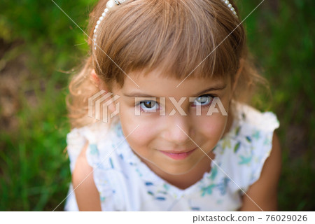 Llittle girl child outdoor in summer day. 76029026