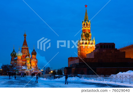 Spasskaya Tower and Saint Basils Cathedral on Red Square in Moscow on winter evening 76029040