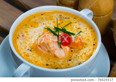 Creamy salmon soup with baguette Creamy salmon soup with baguette 76029317