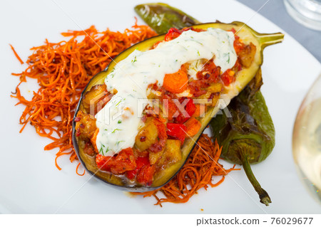 Eggplant baked with vegetables and tzatziki 76029677